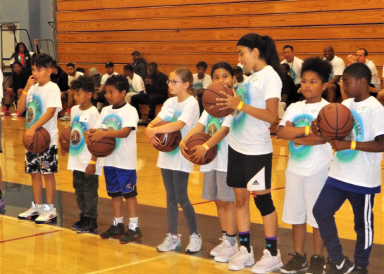 Junior Deputy Program participants learn basketball skills at Go Beyond the Arc clinics.